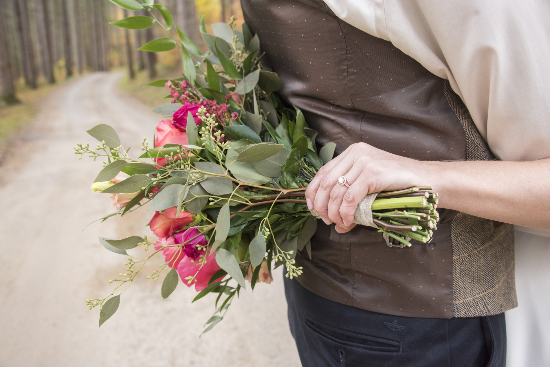 Brides rings and bouquet at Lake Logan Wedding