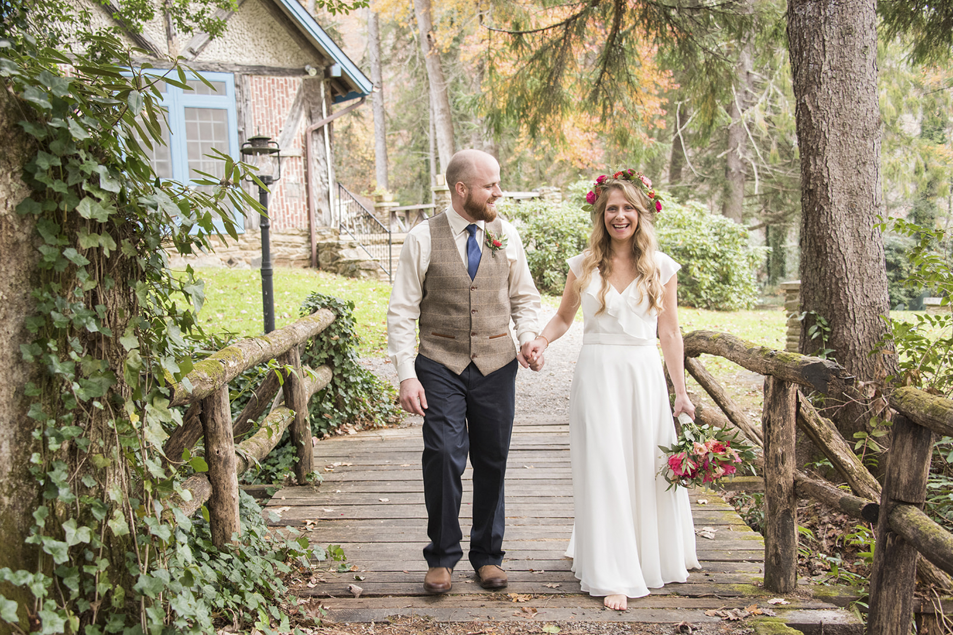 Couple walking on bridge at Lake Logan Wedding