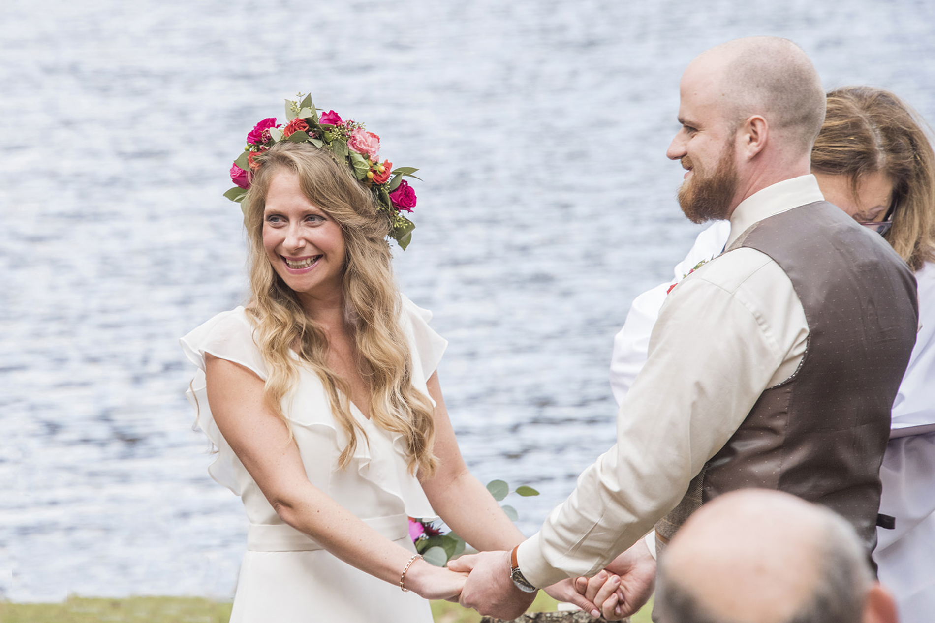 Bride smiling at guests during wedding ceremony