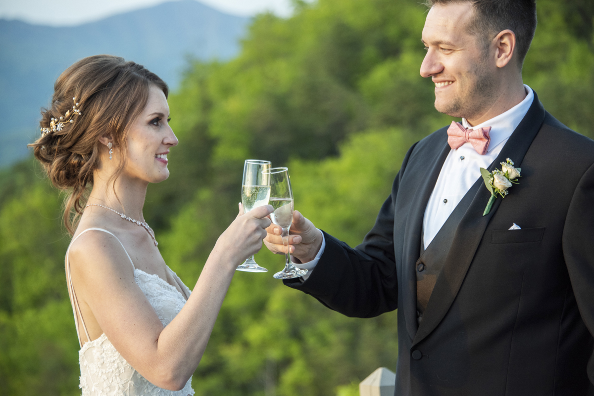 Couple sharing cheers on mountain top at Hawkesdene Wedding