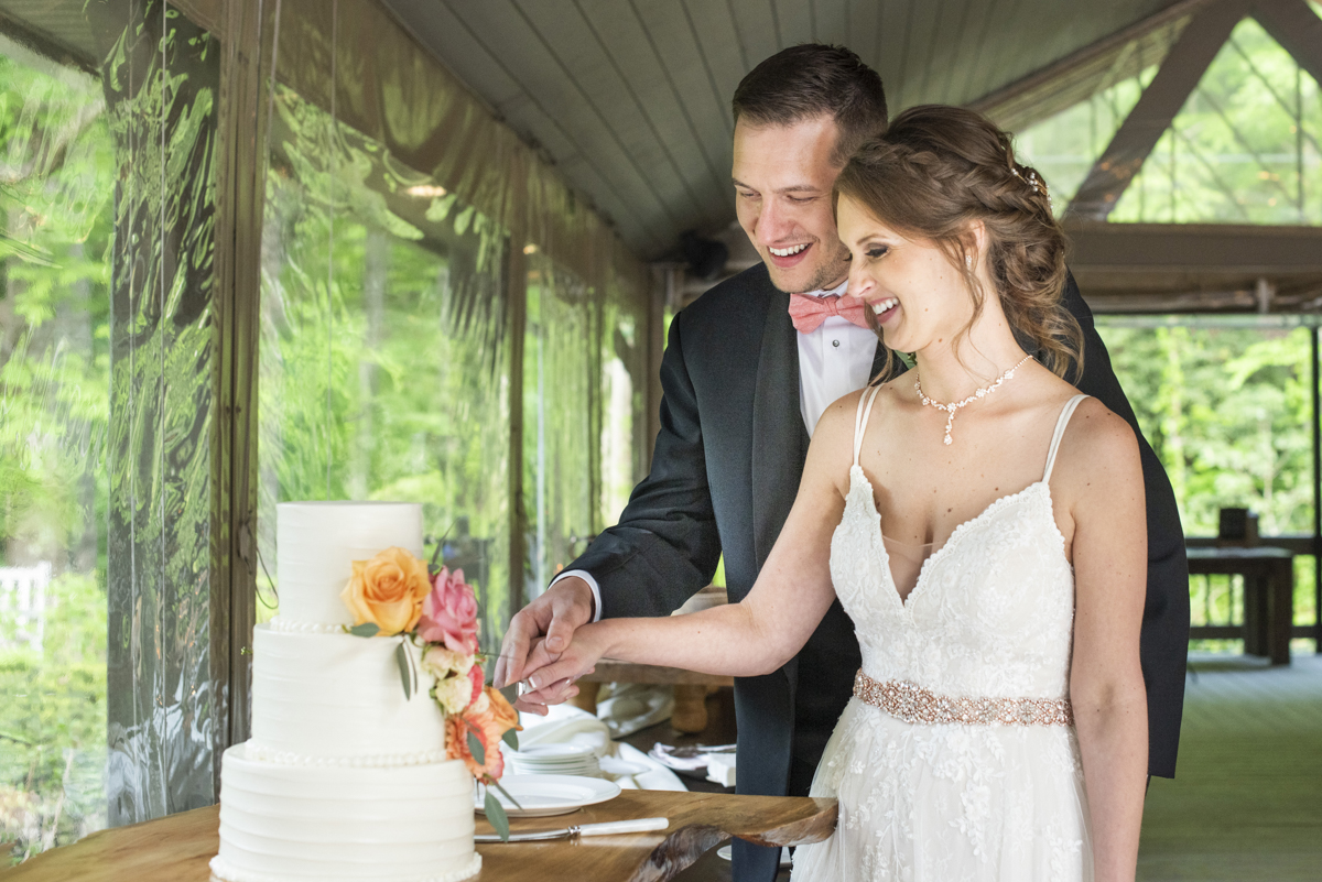 Couple cutting cake at Hawkesdene Wedding