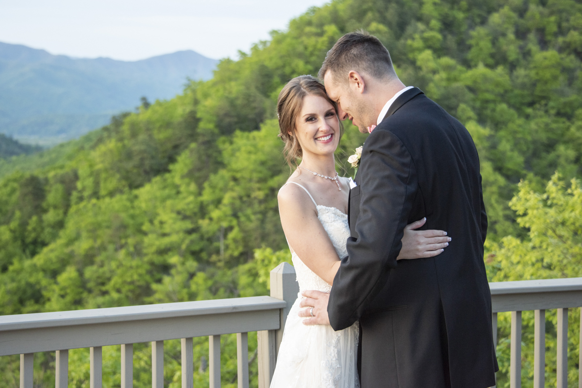 Couple snuggling on mountain top at Hawkesdene Wedding
