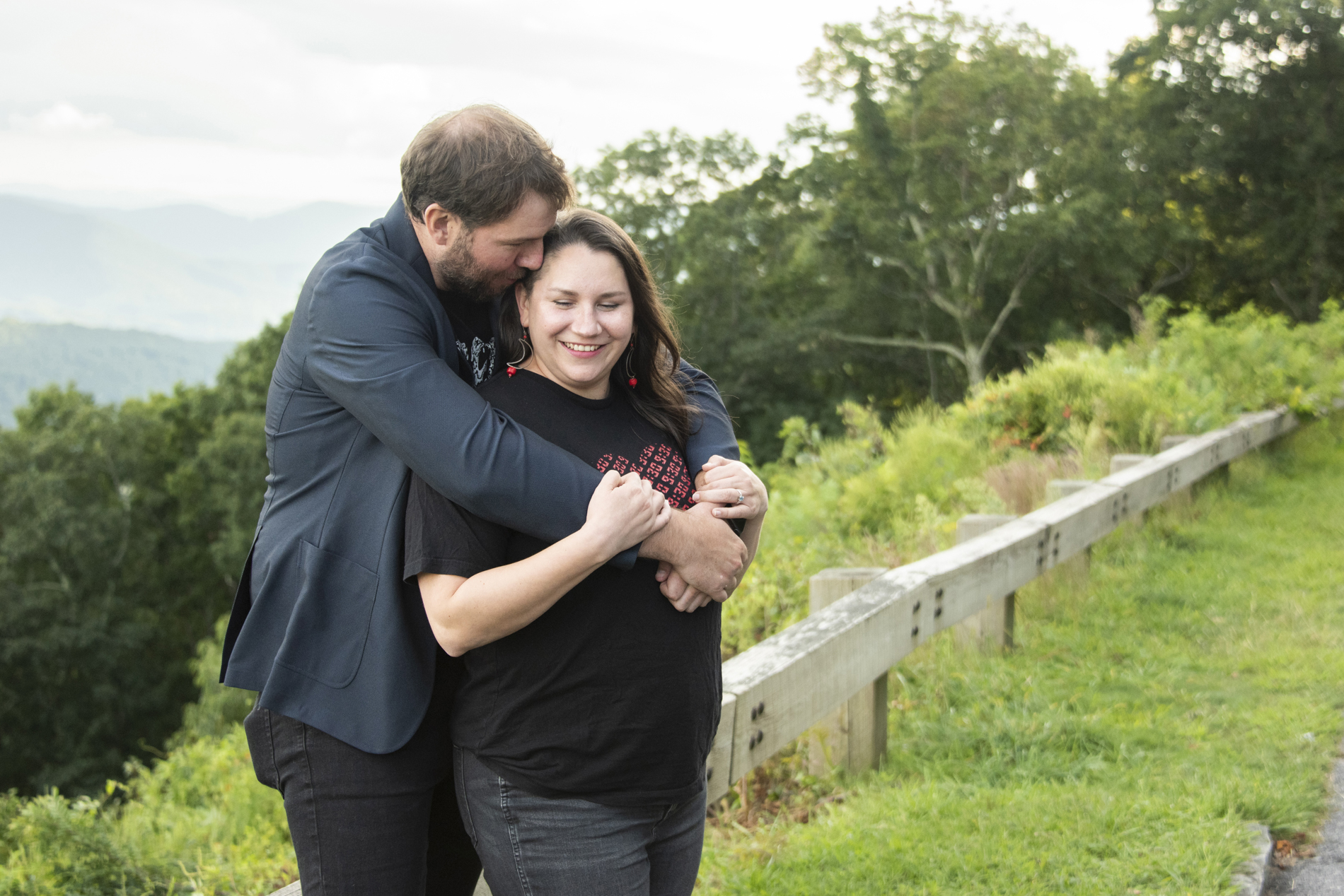 Couple snuggling with mountains behind during Black Mountain Photography