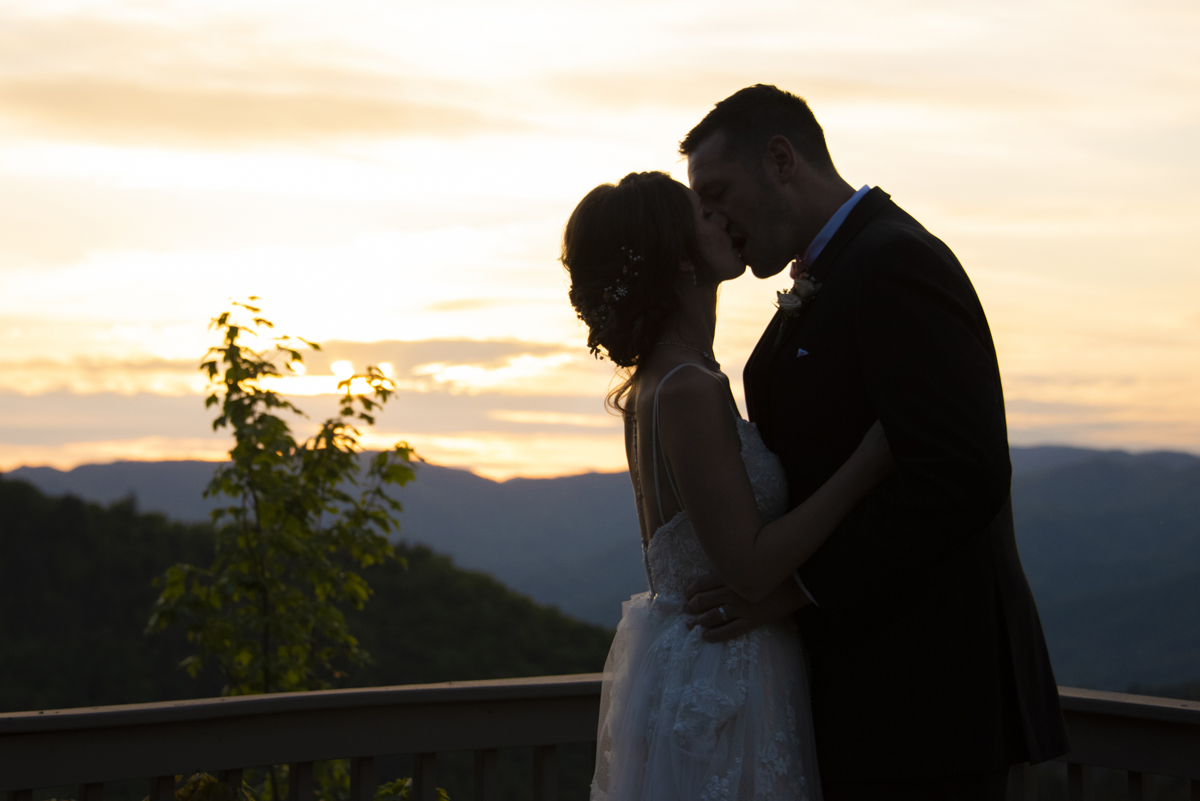 Couple kissing on mountain top at Hawkesdene Wedding