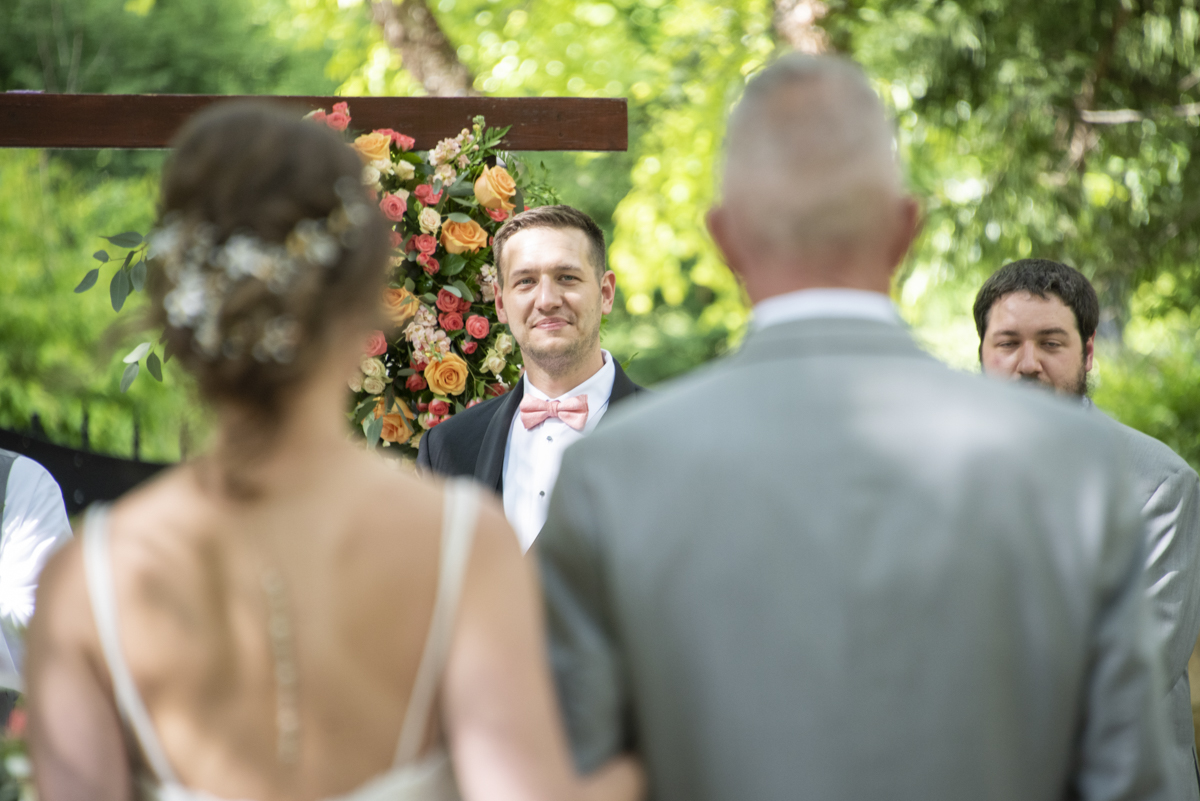 Groom seeing bride at wedding ceremony