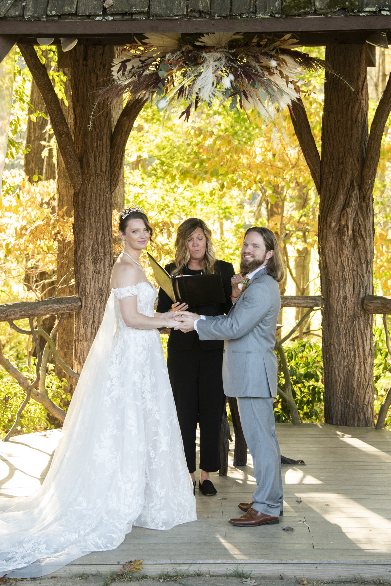 Couple looking at guests during wedding ceremony at The Farm Wedding Venue