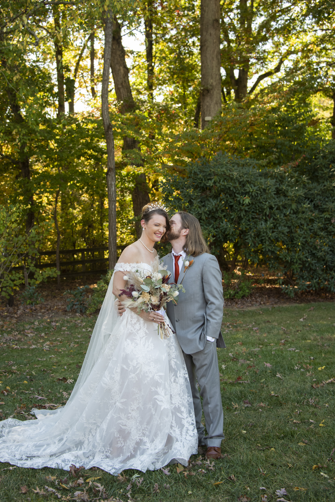 Groom snuggling bride at The Farm Wedding Venue