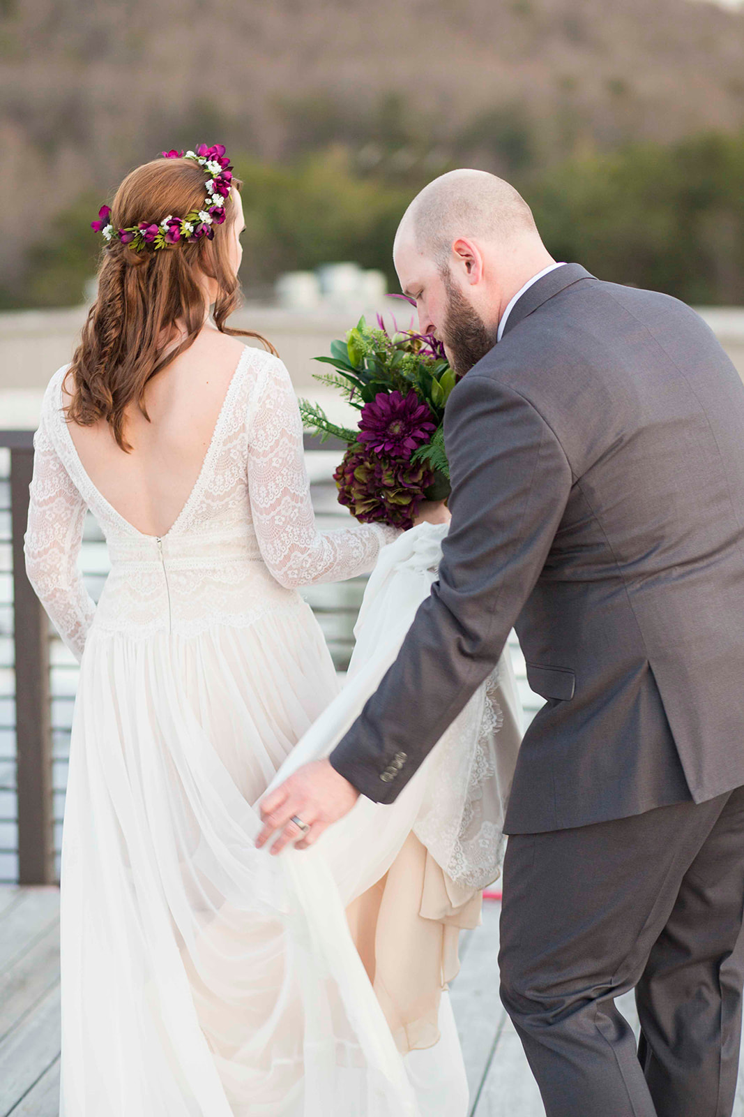 Groom carrying bride's train
