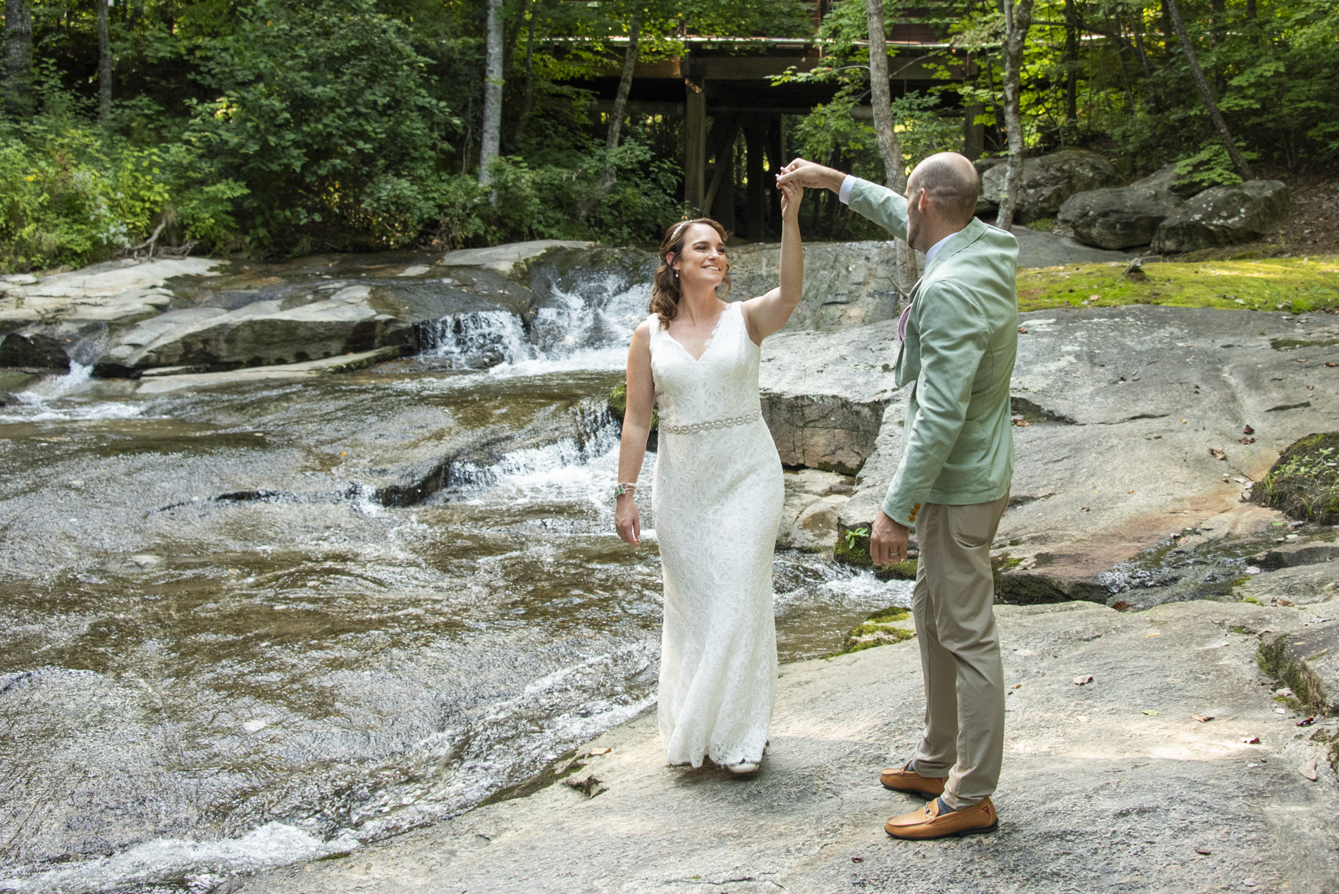 Couple dancing next to creek