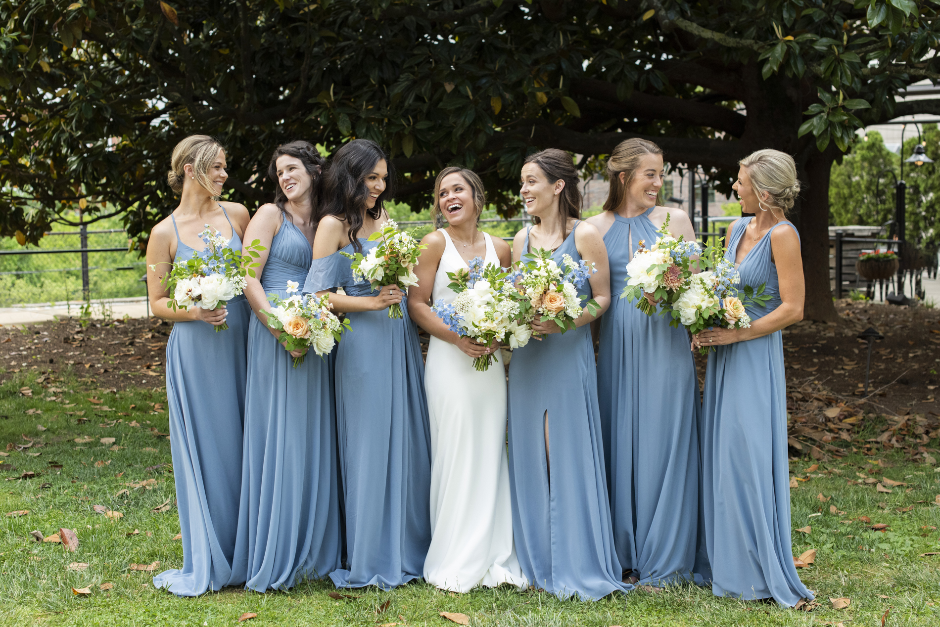 Bride laughing with bridesmaids