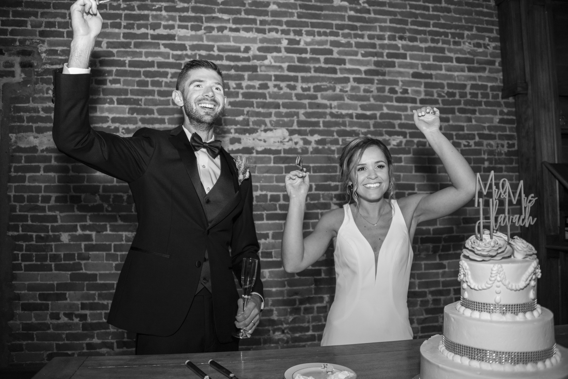 Couple celebrating after cutting wedding cake at Century Room on the Park