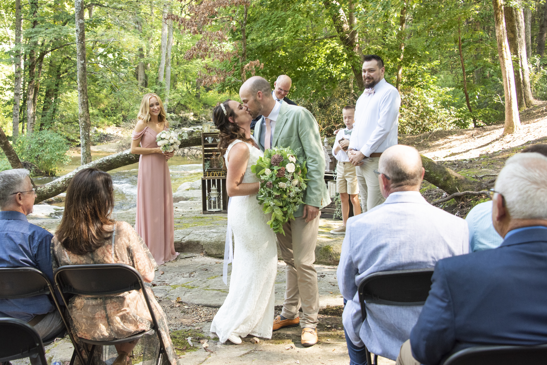 Couple kissing during wedding ceremony at Lake Lure Wedding