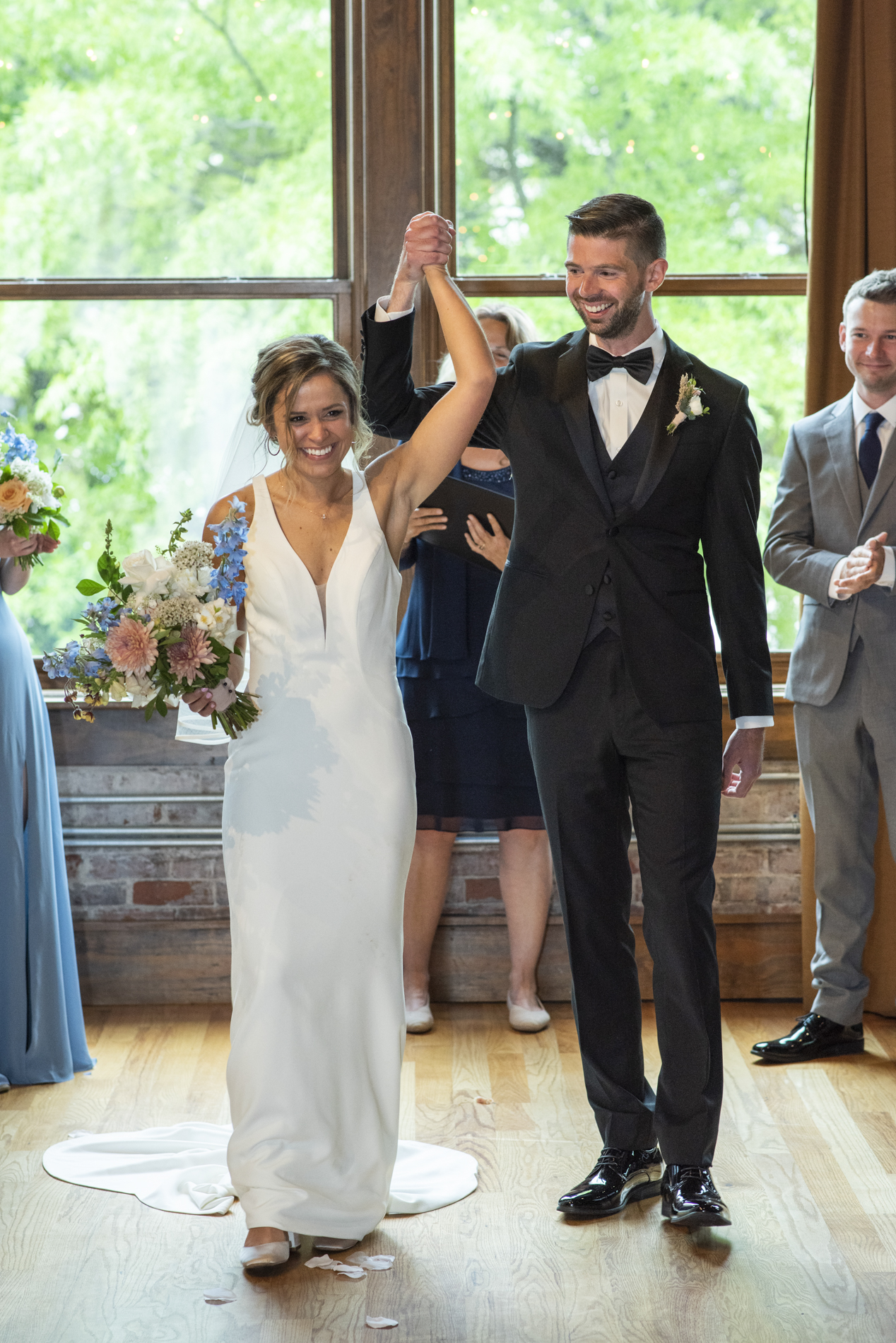 Couple recessing after wedding ceremony at Century Room on the Park