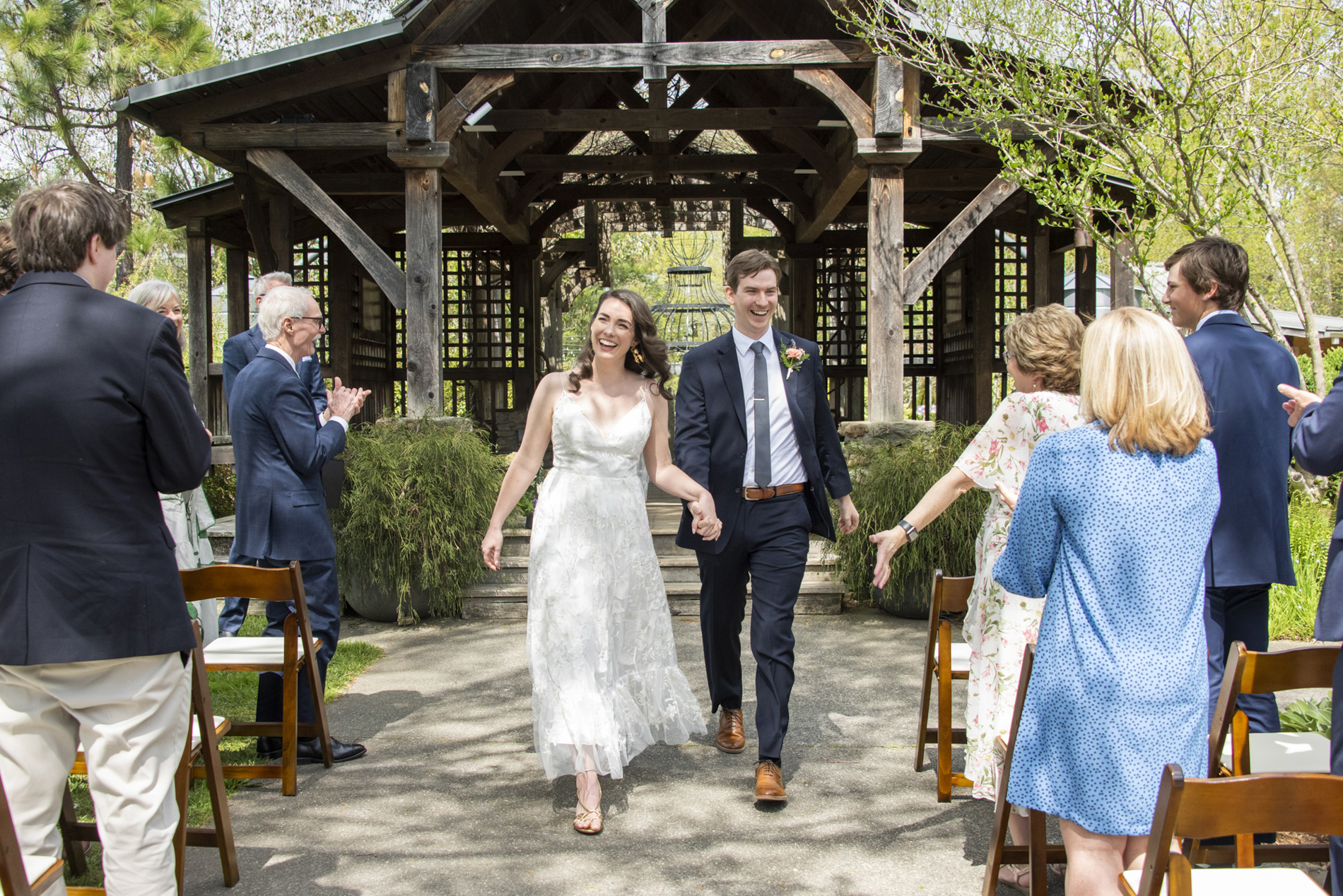 Couple walking down aisle at NC Arboretum weddings