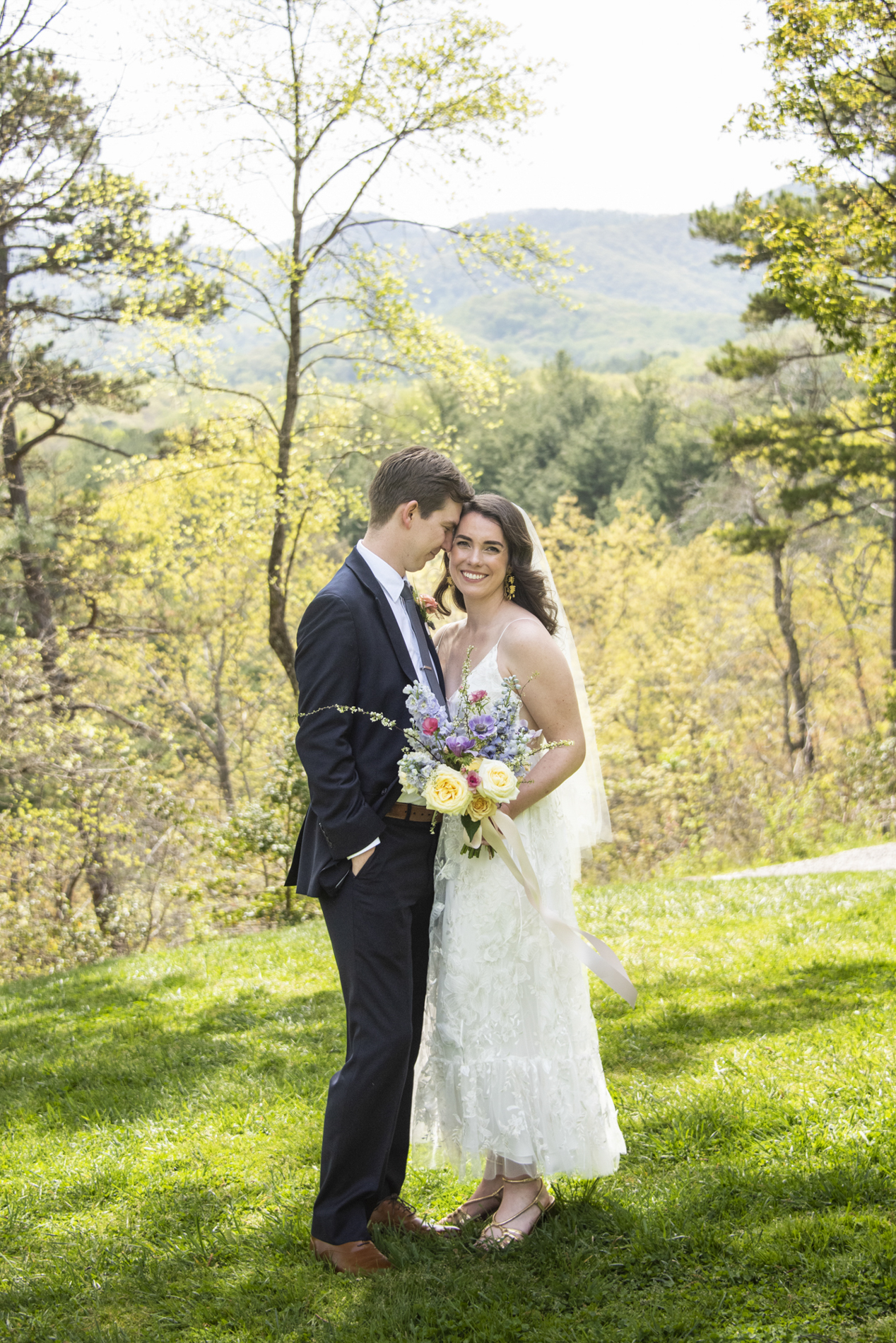 Couple snuggling in front of mountain view at NC Arboretum weddings