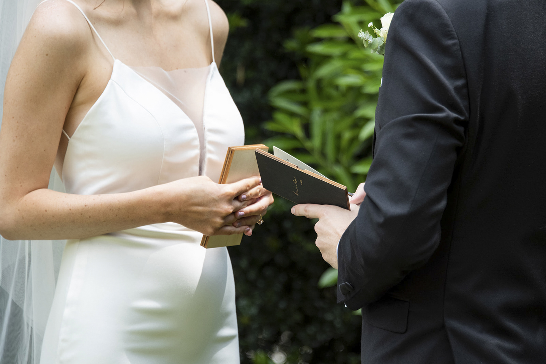 couple holding vow books