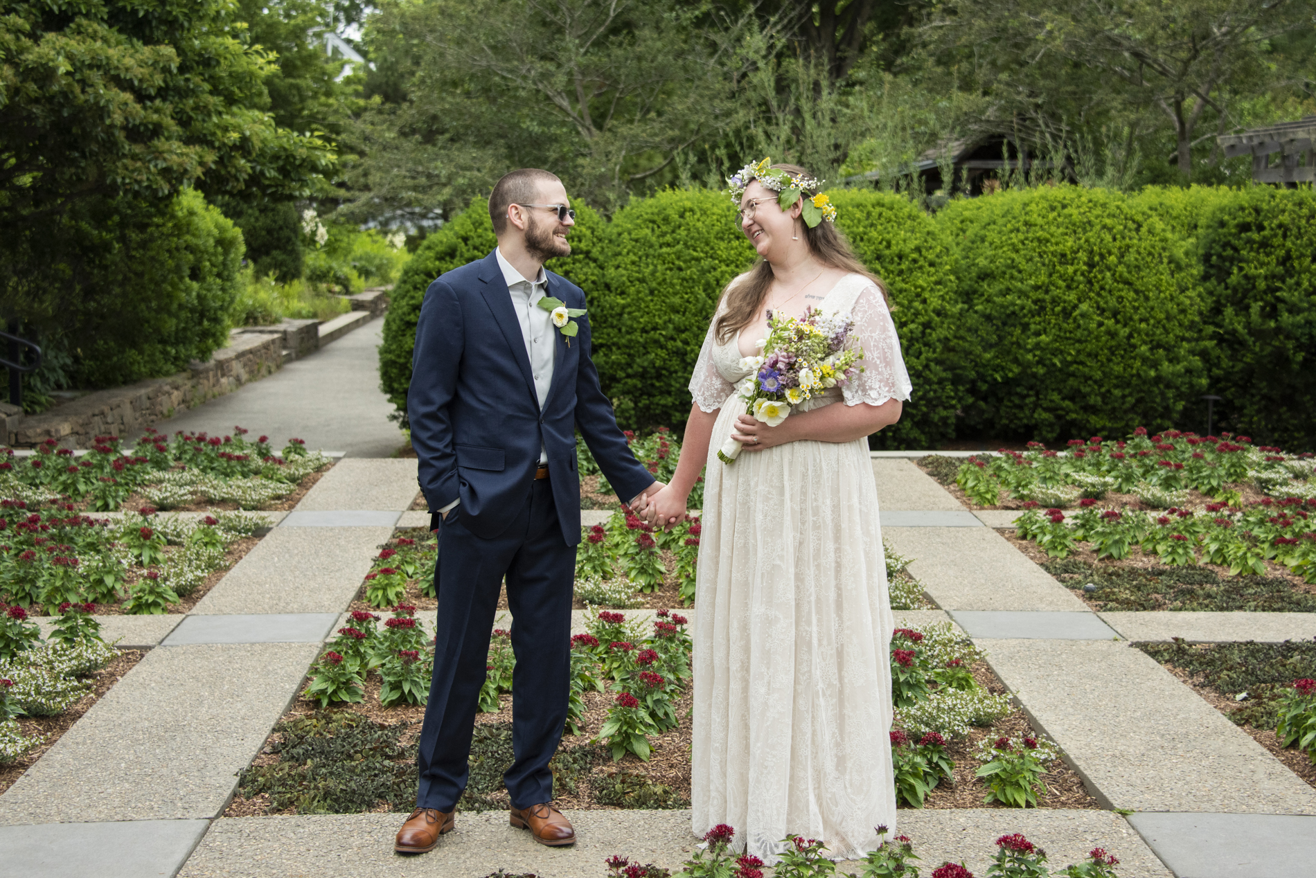 Couple holding hands in garden at north carolina arboretum wedding