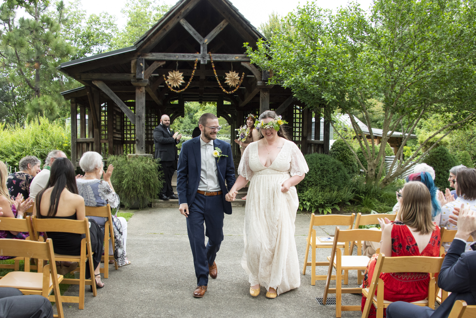 Couple walking down aisle at north carolina arboretum wedding