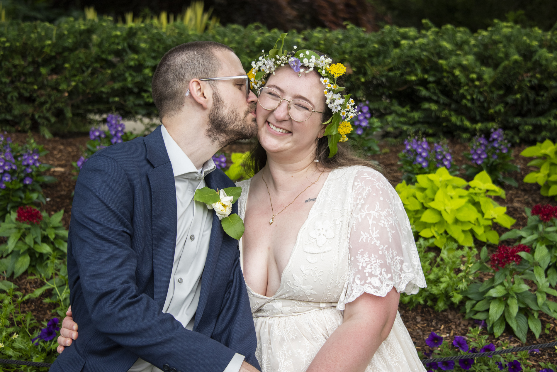 Groom kissing bride on cheek