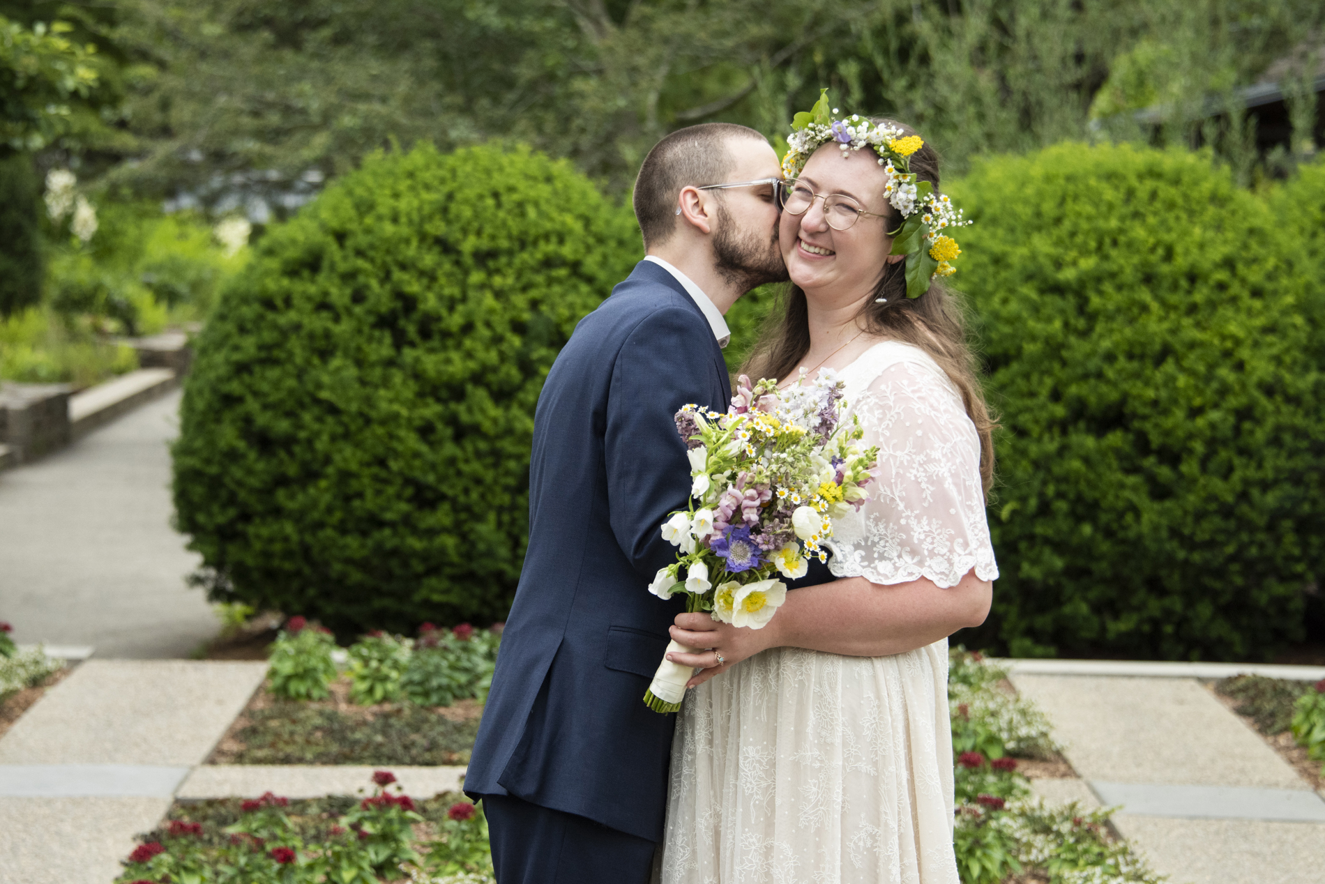 Groom kissing bride on cheek