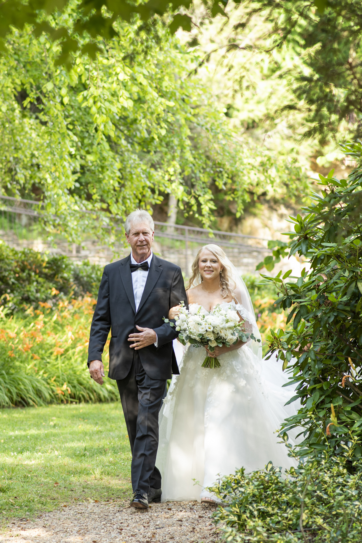 Bride and father walking into wedding ceremony