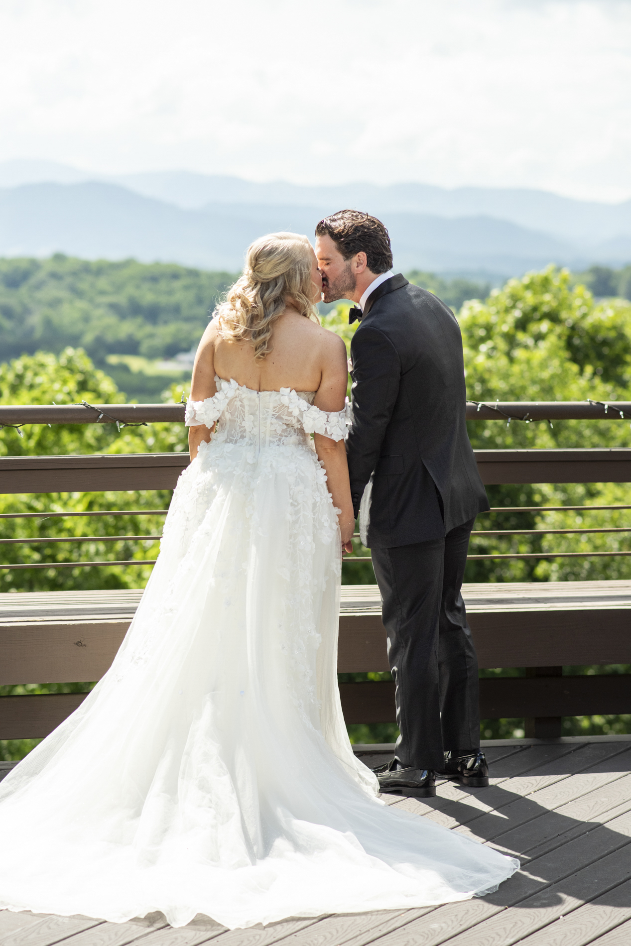 Couple kissing with mountain views at wedding at Crest Center and Pavilion