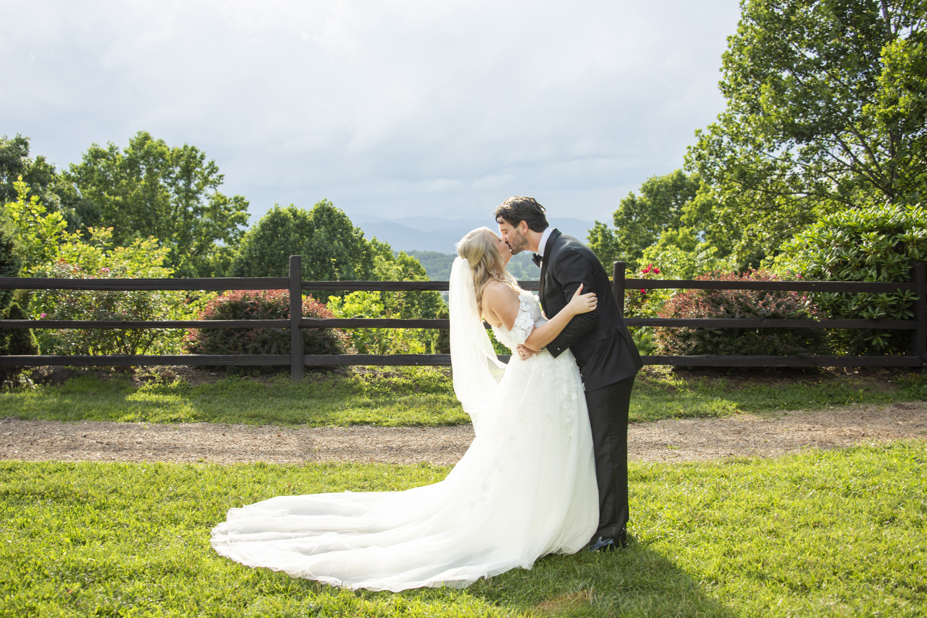 Couple kissing with mountain views at wedding at Crest Center and Pavilion