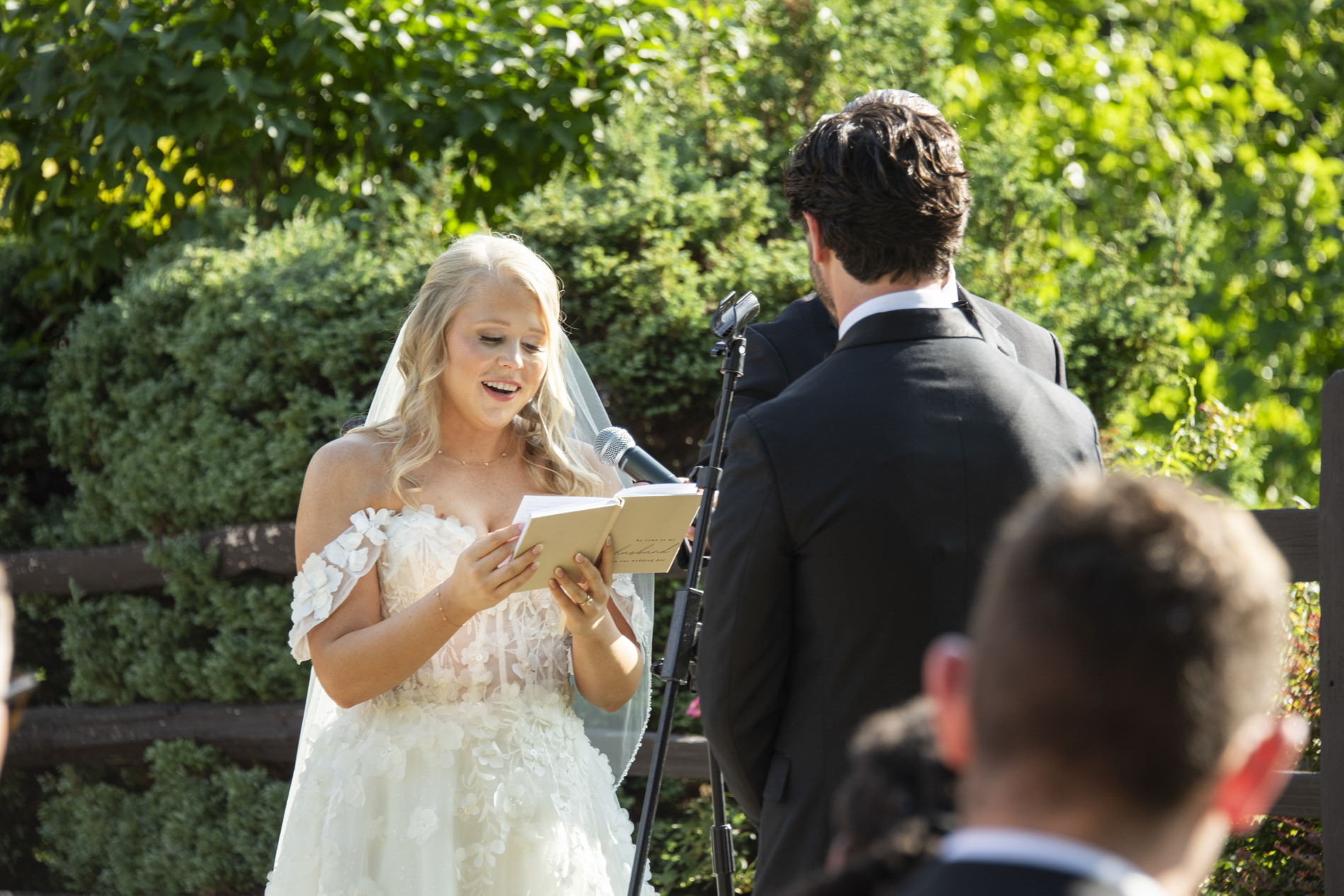 wedding ceremony with bride reading vows