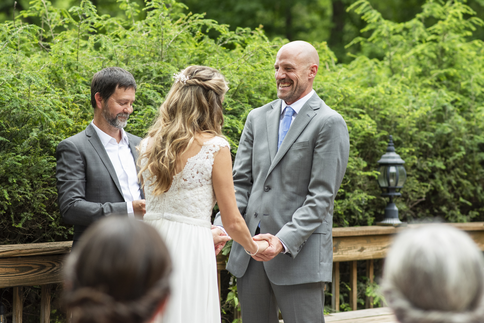 groom laughing during wedding ceremony