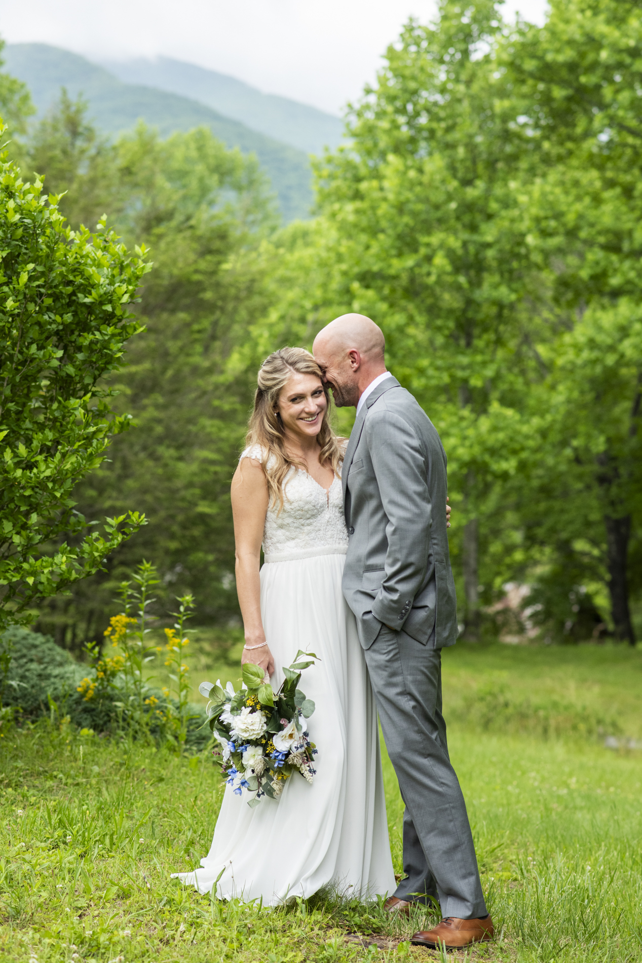 couple snuggling at wedding at Mount Mitchell Wedding