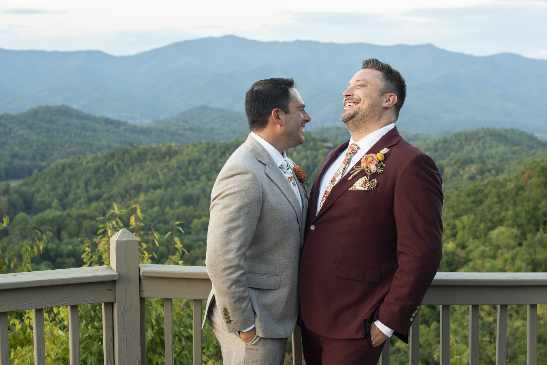 Couple laughing at same sex wedding at Hawkesdene Estate