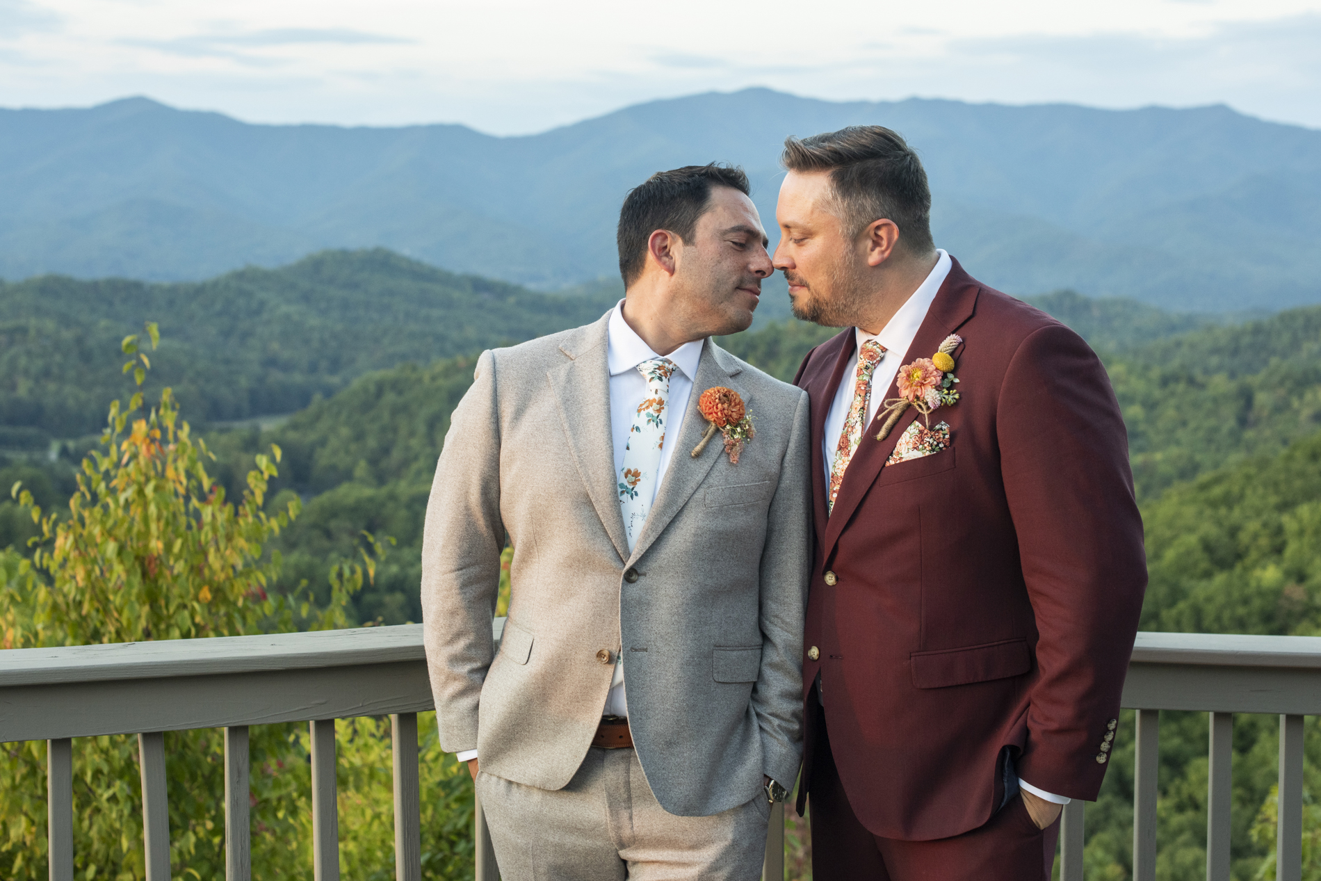 Couple snuggling at same sex wedding at Hawkesdene Estate