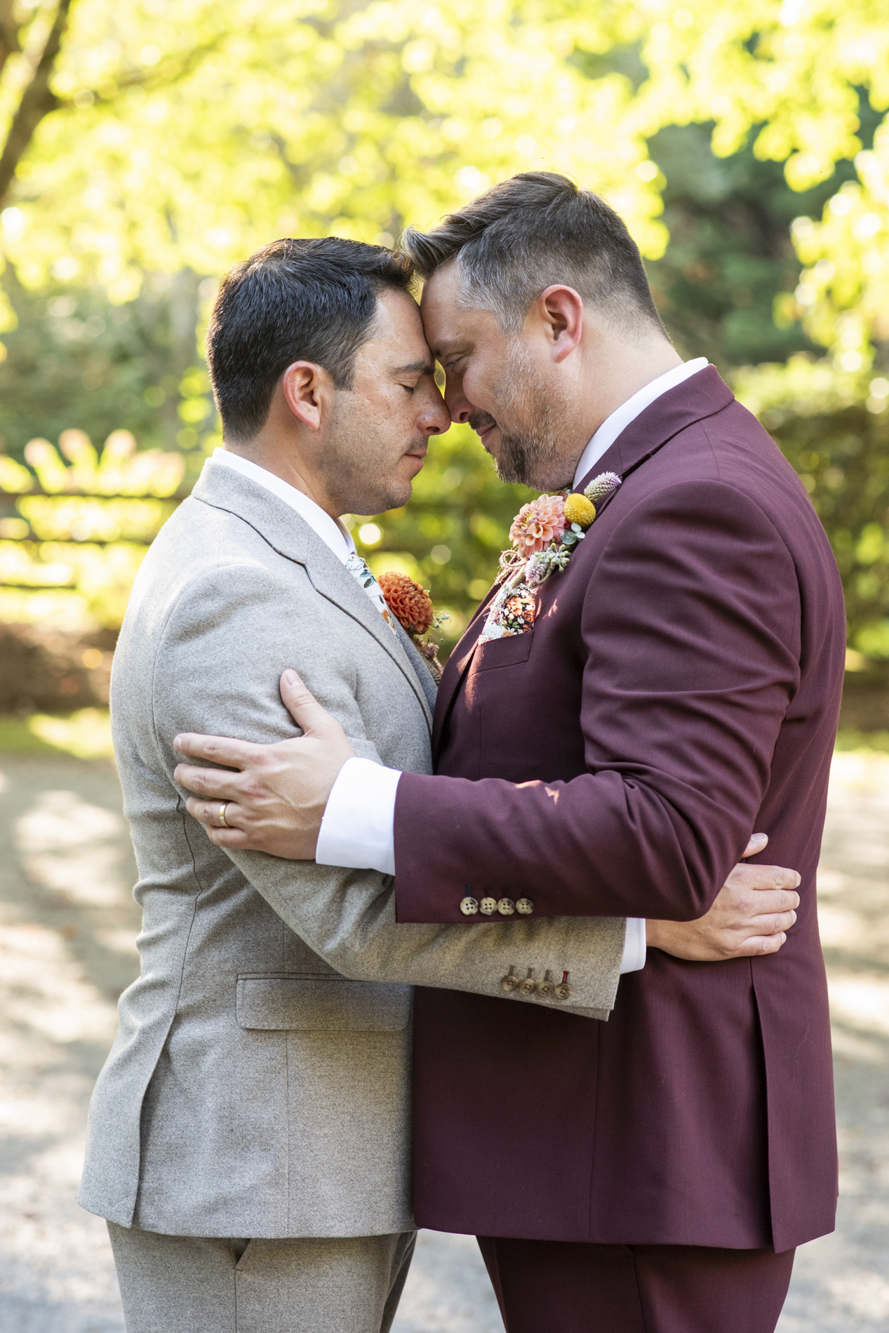 Couple snuggling at same sex wedding