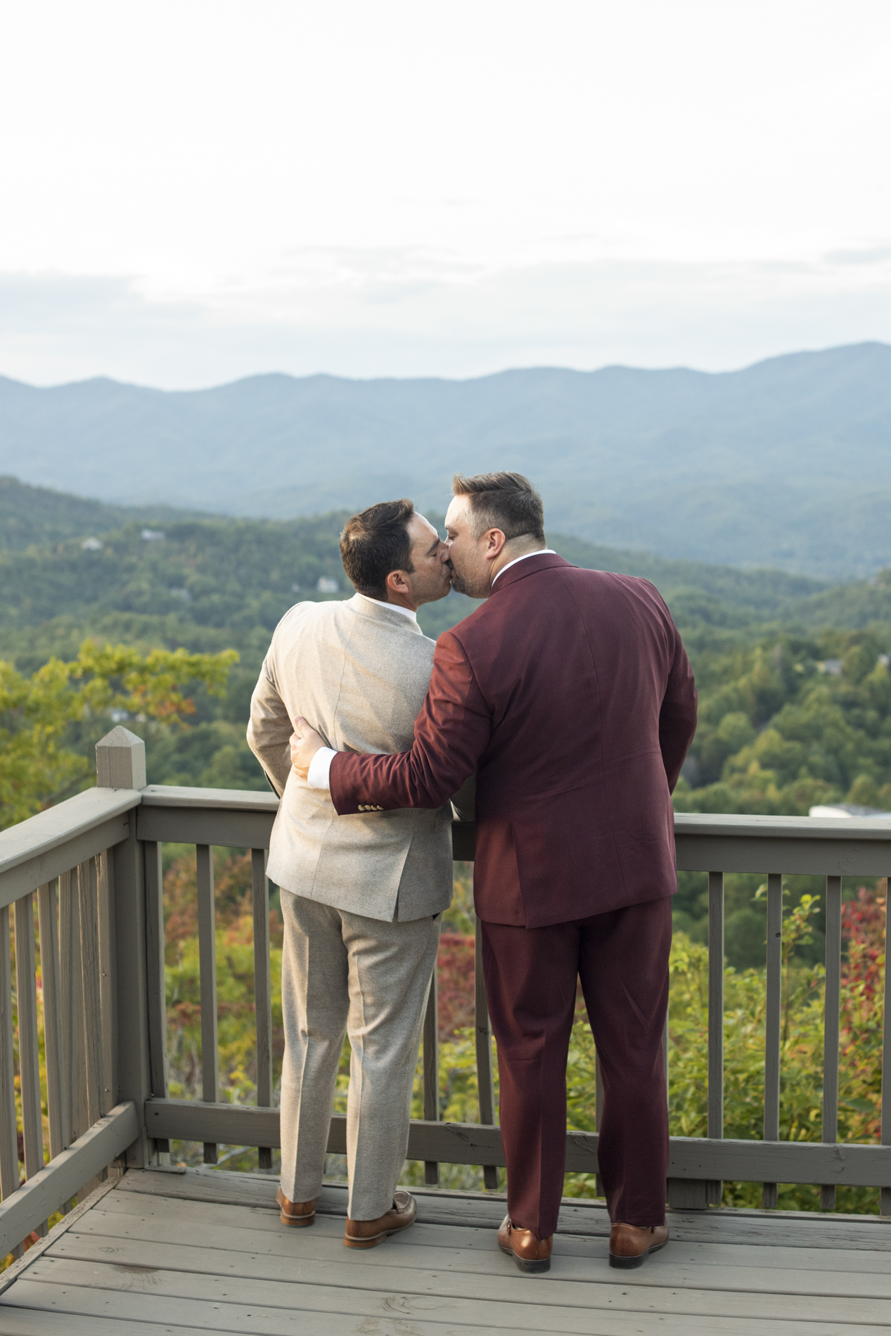 Couple kissing at lgbtq mountain top wedding at Hawkesdene Estate