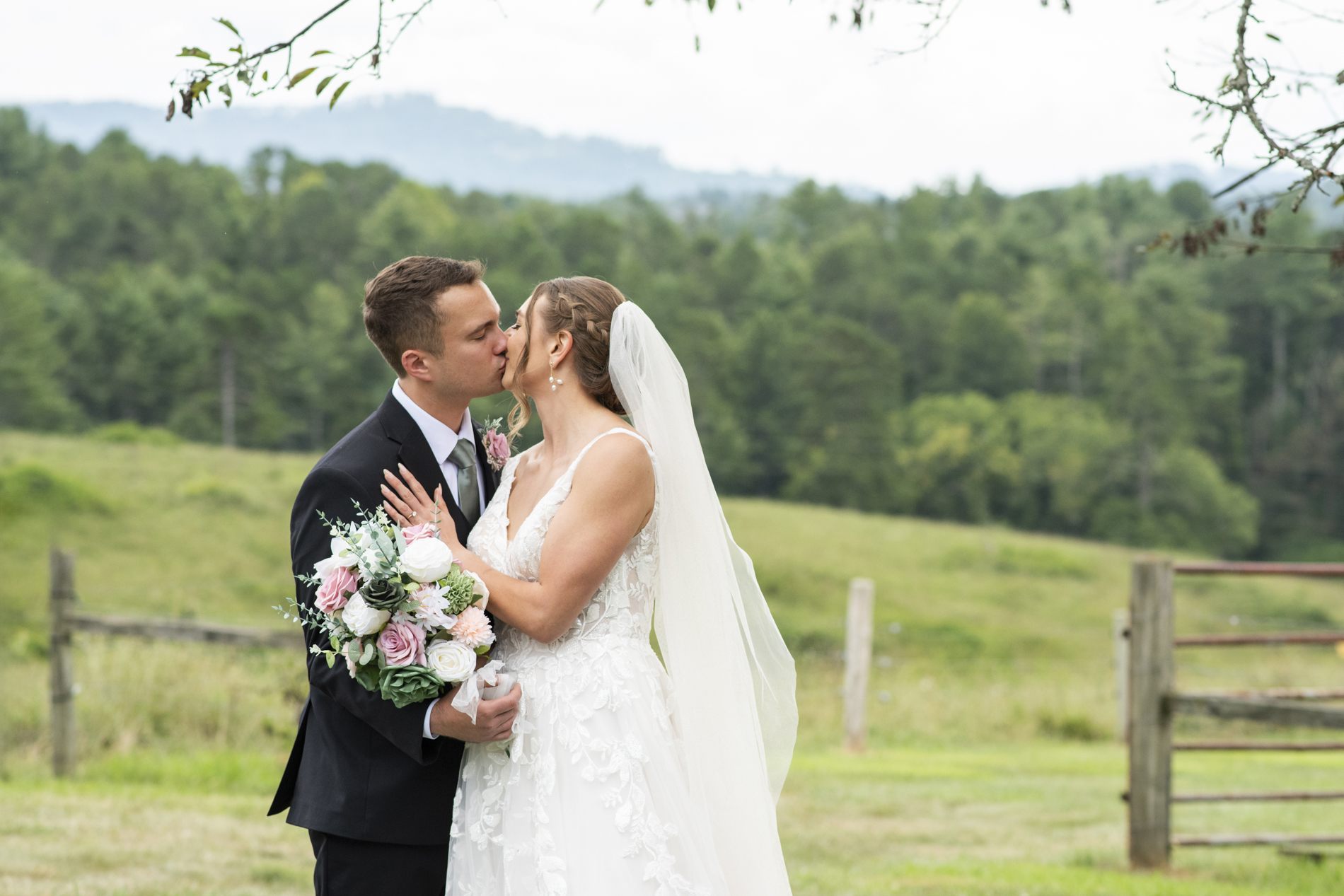 Emerald Ridge Wedding with couple kissing in front of mountain view