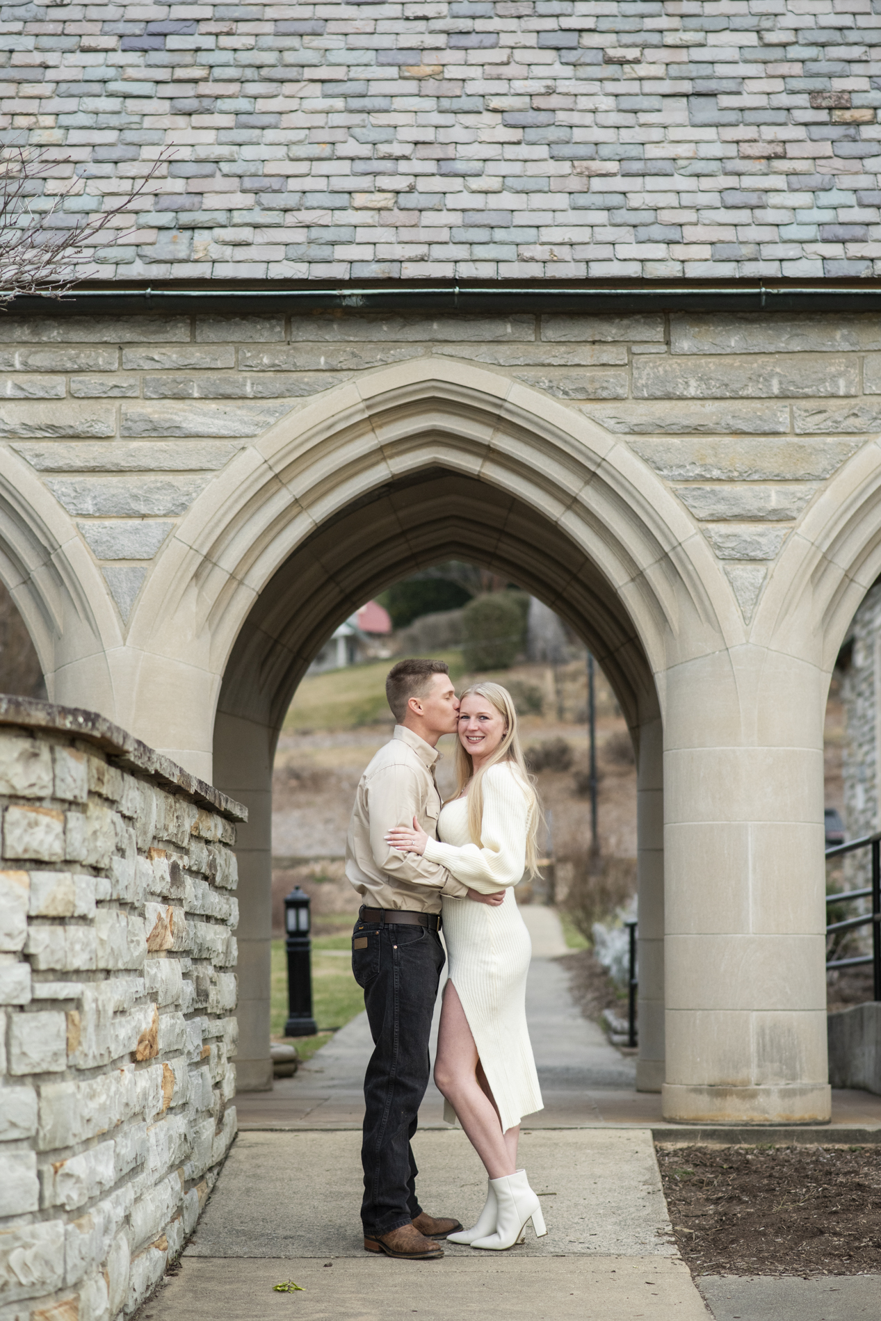 Couple snuggling at lake junaluska chapel