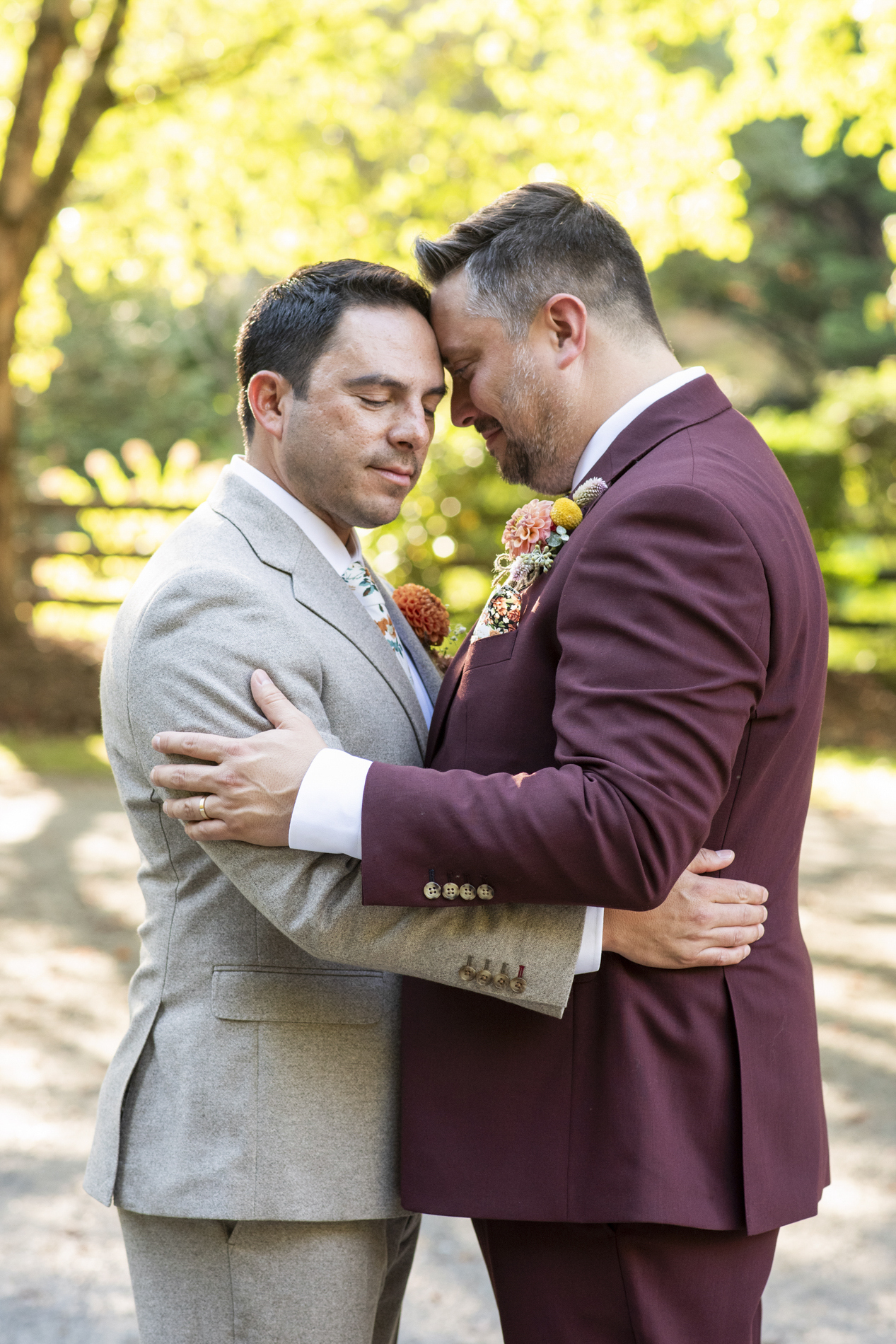 Queer couple snuggling at wedding