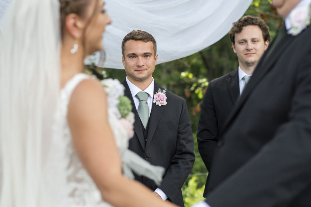 groom looking at bride during wedding ceremony