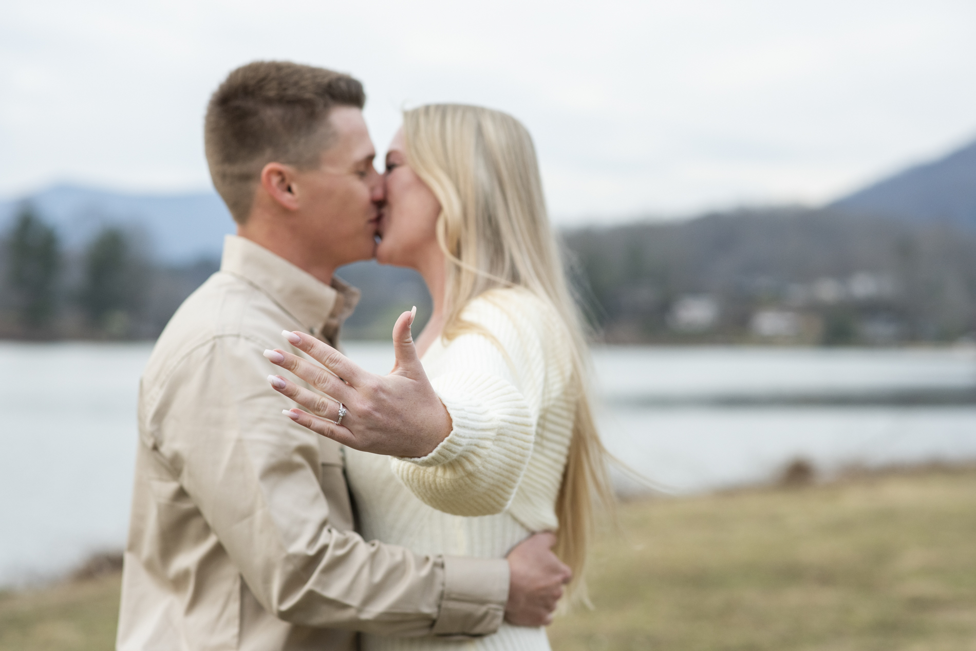 couple showing engagement ring at lake junaluska