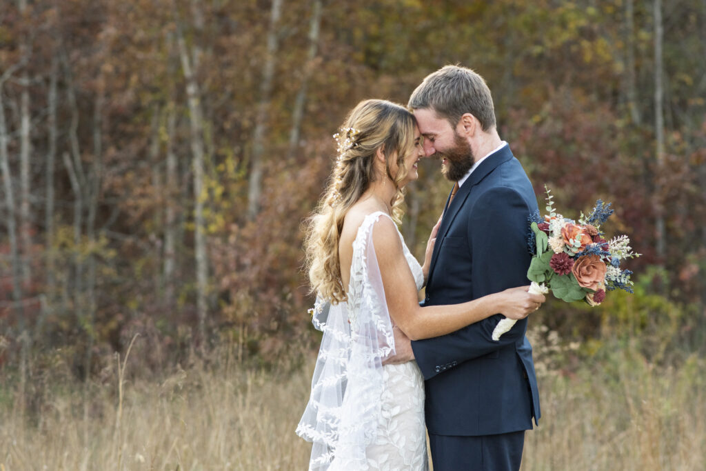 couple snuggling at wedding at Emerald Ridge Asheville NC