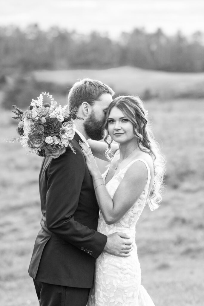 couple snuggling at wedding at Emerald Ridge Asheville NC