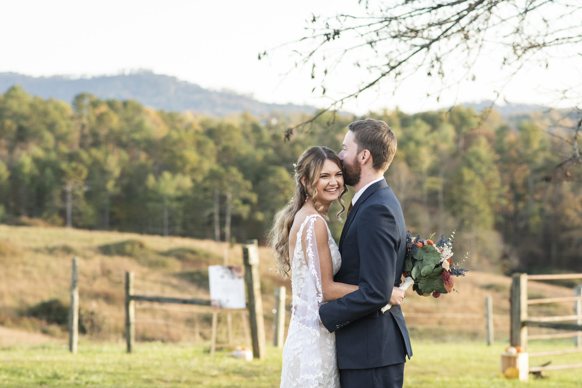 couple snuggling at wedding at Emerald Ridge Asheville NC