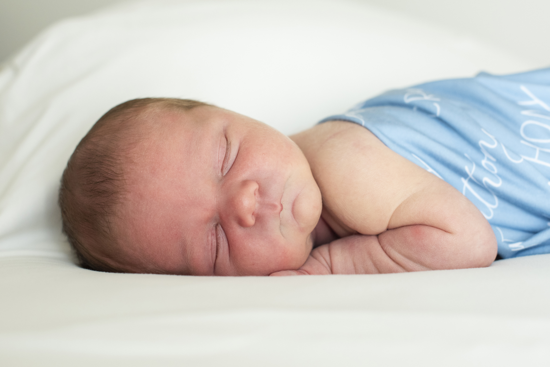 newborn baby on belly at newborn photography Asheville NC