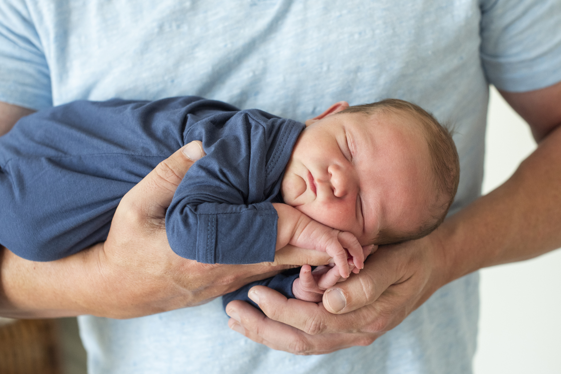 newborn baby in Dads arms at newborn photography Asheville NC