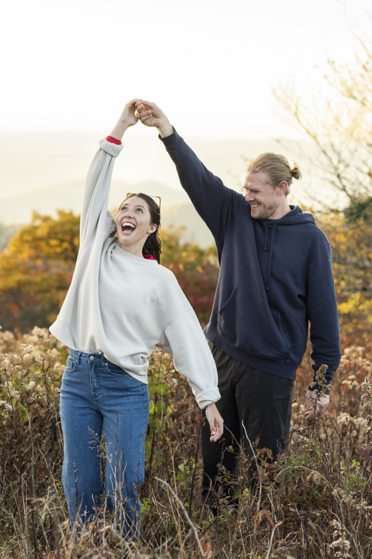 Couple dancing on mountain top with Asheville proposal photographer