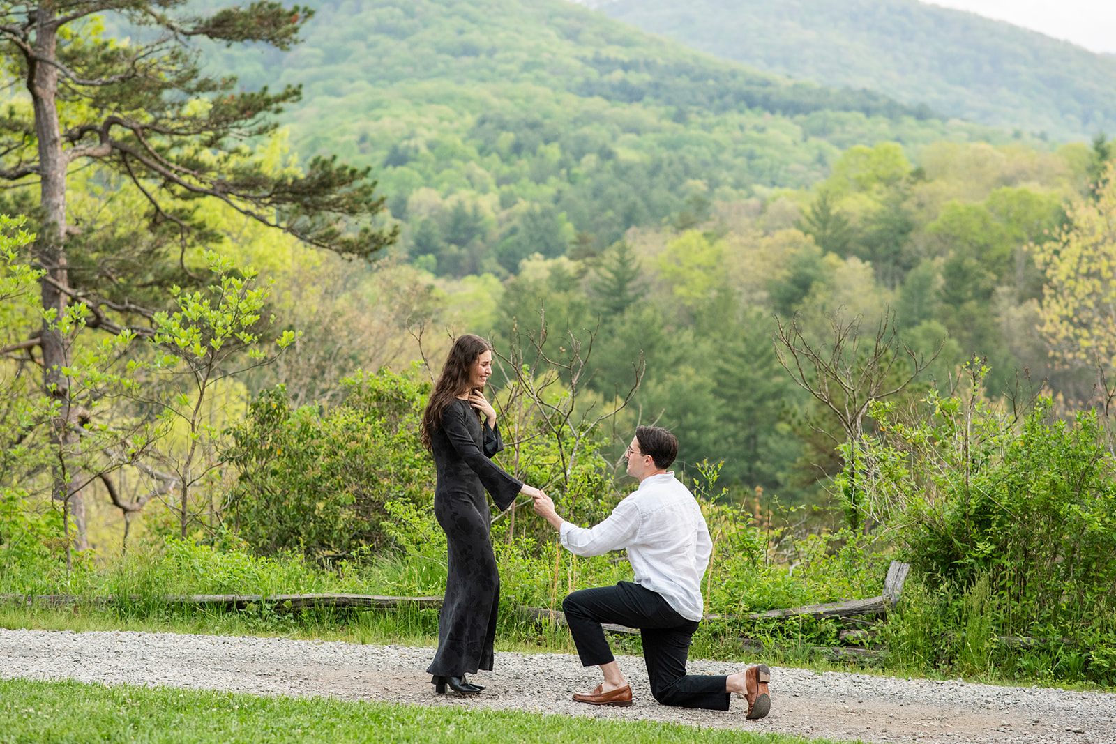 man on one knee proposing at NC Arboretum engagement