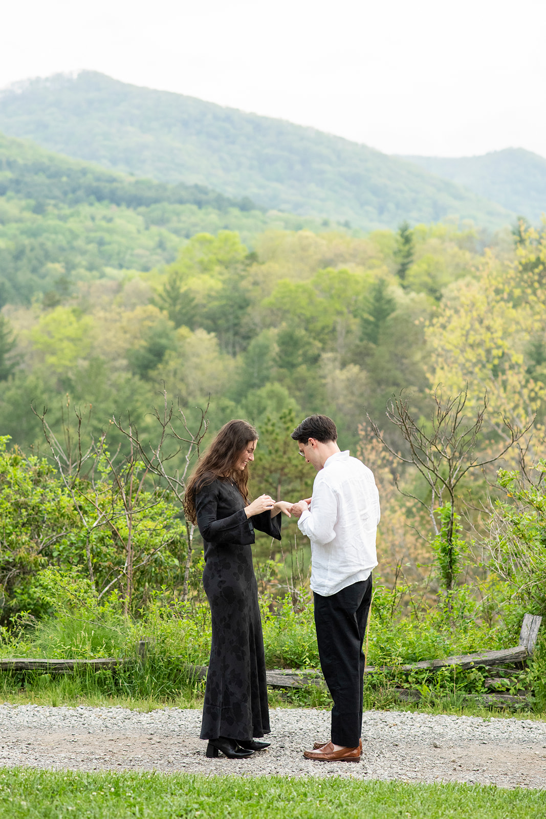 Man giving ring to woman after proposal at NC Arboretum engagement