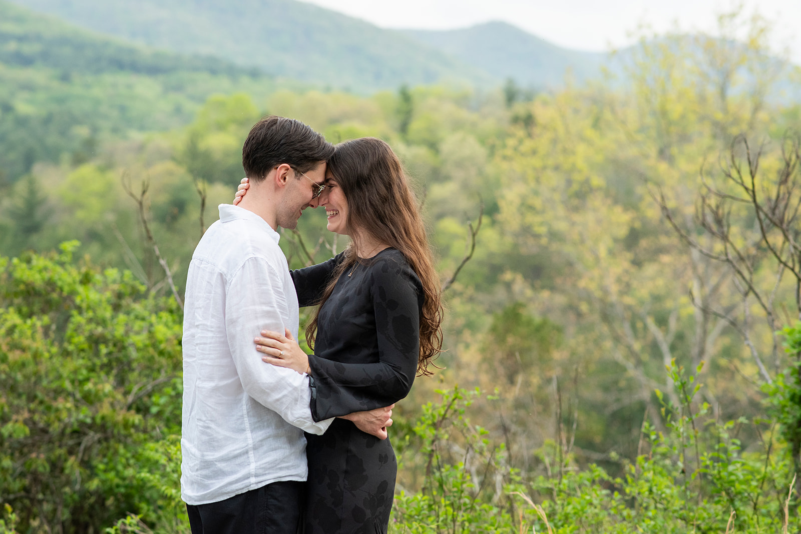 Couple smiling after proposal at NC Arboretum engagement