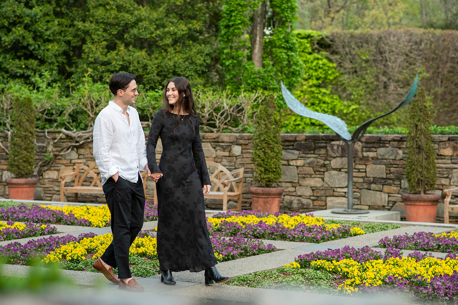 Couple walking through flower garden