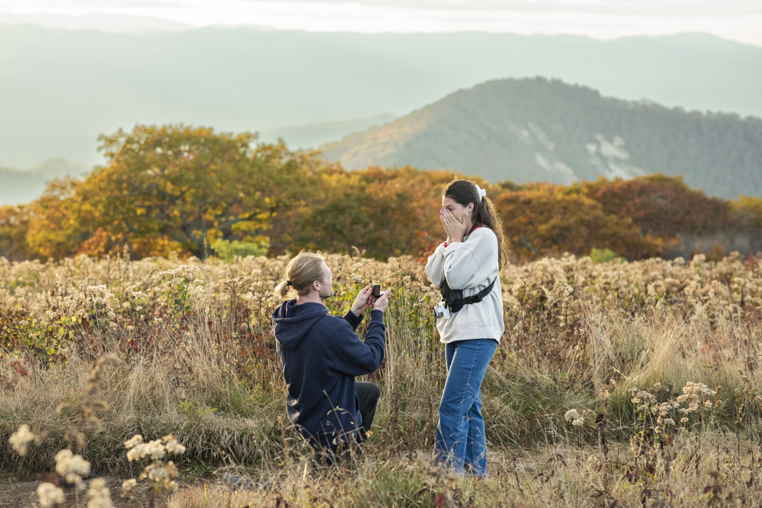 Man proposing to woman on mountain top for Asheville proposal photographer